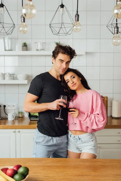 Selective Focus Young Couple Holding Glasses Wine Looking Camera Kitchen — Stock Photo, Image