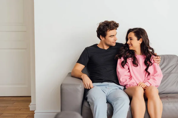 Selective Focus Handsome Young Man Hugging Smiling Woman Sofa Living — Stock Photo, Image