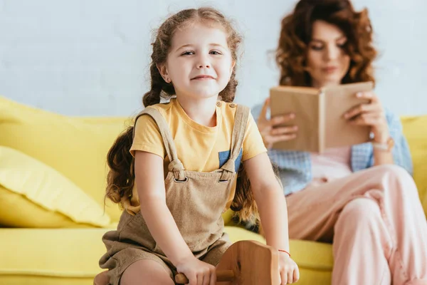 Selective Focus Smiling Child Riding Rocking Horse Smiling Camera While — Stock Photo, Image