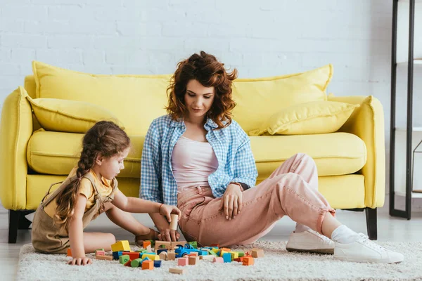 Adorable Kid Holding Block While Playing Floor Young Nanny — Stock Photo, Image