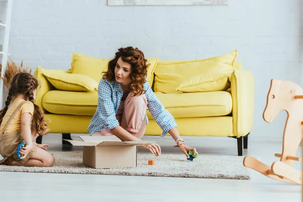 Young Nurse Taking Multicolored Cubes Carton Box Child While Sitting — Stock Photo, Image