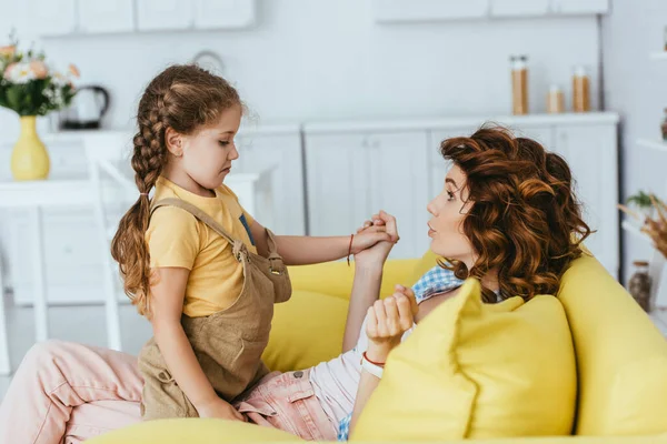 Surprised Babysitter Holding Hand Offended Kid While Sitting Sofa Kitchen — Stock Photo, Image