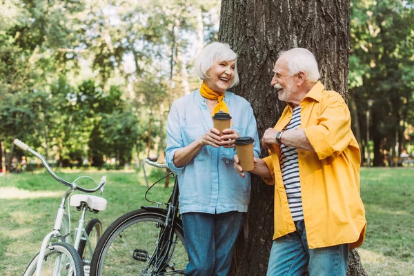 Selective Focus Elderly Couple Paper Cups Smiling Each Other Bikes — Stock Photo, Image