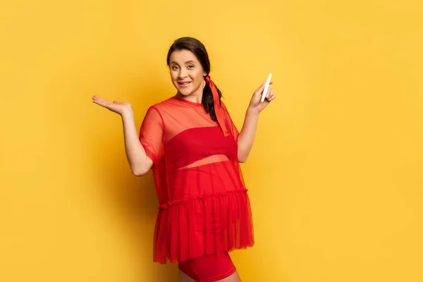 Pregnant Woman Red Outfit Holding Pregnancy Test While Standing Yellow — Stock Photo, Image