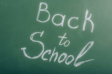 back to school lettering on green chalkboard, top view clipart