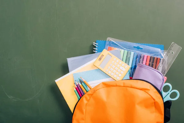 Top View Yellow Backpack Full School Supplies Green Chalkboard — Stock Photo, Image