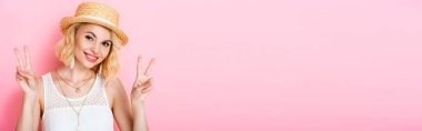 panoramic crop of woman in straw hat showing peace sign on pink  clipart