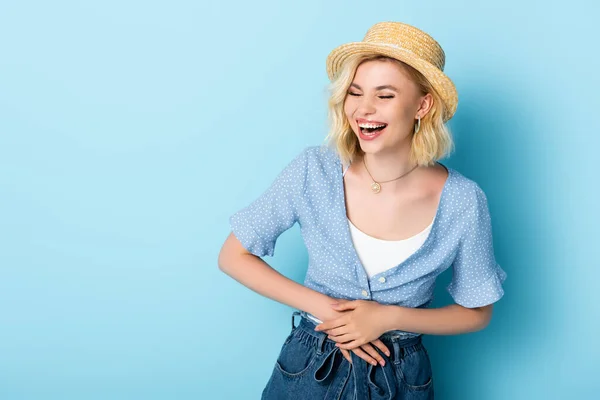 Woman Straw Hat Laughing Touching Belly Blue — Stock Photo, Image