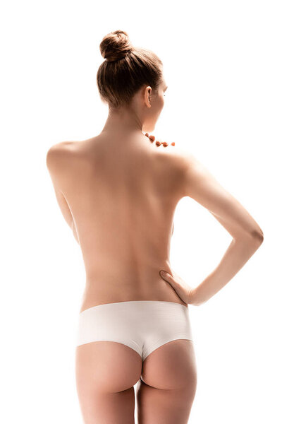 back view of young woman standing with hand on hip isolated on white 