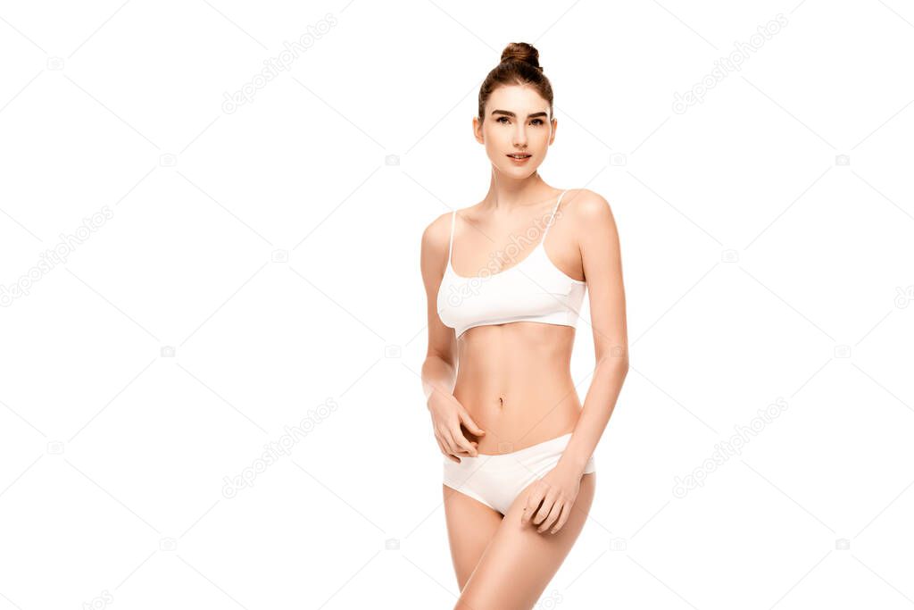 young woman with perfect body in panties and top standing isolated on white