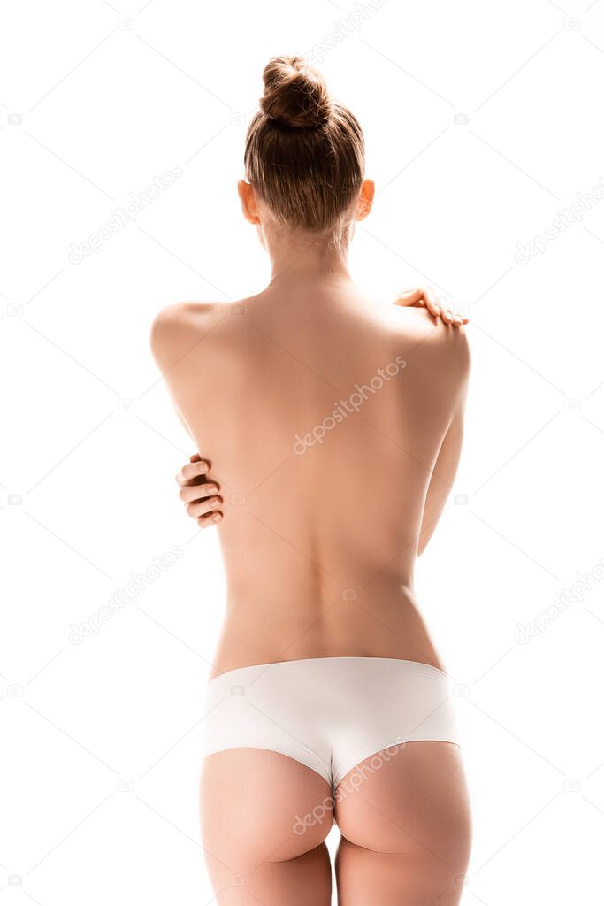 back view of woman standing and touching perfect body isolated on white 