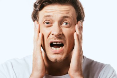 Shocked man touching face and looking at camera isolated on white clipart