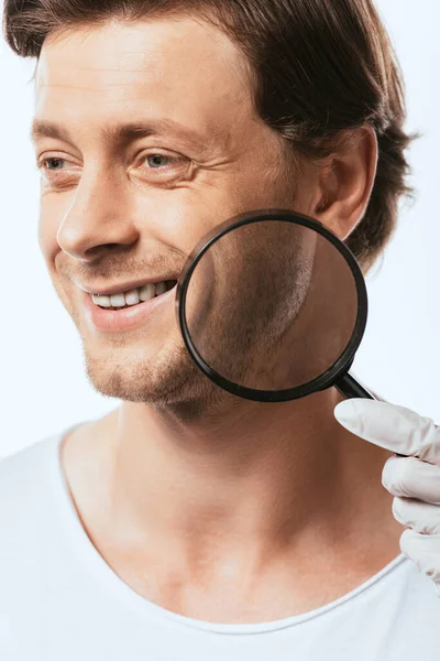 Dermatologist Holding Magnifying Glass Cheek Young Man Isolated White — Stock Photo, Image