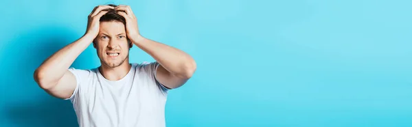 Horizontal Crop Angry Man Hands Head Looking Camera Blue Background — Stock Photo, Image