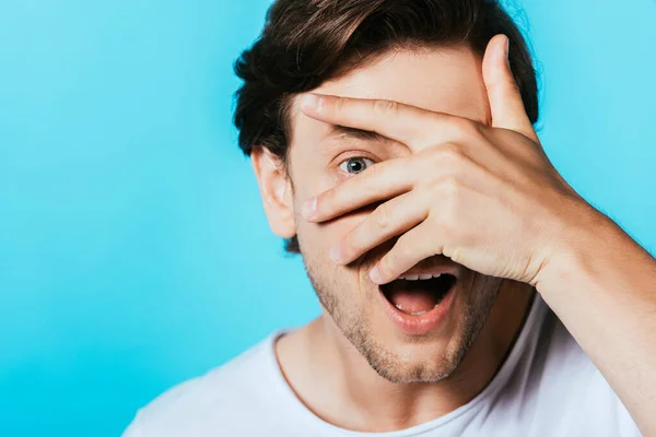 Excited Man Hand Face Looking Camera Isolated Blue — Stock Photo, Image