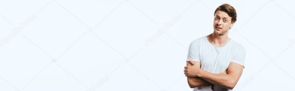 Panoramic concept of confident man with crossed arms looking at camera  isolated on white