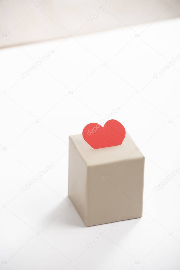 red heart in box on white background, donation concept