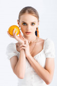 elegantní blondýnka pózující s oranžovou izolované na bílém