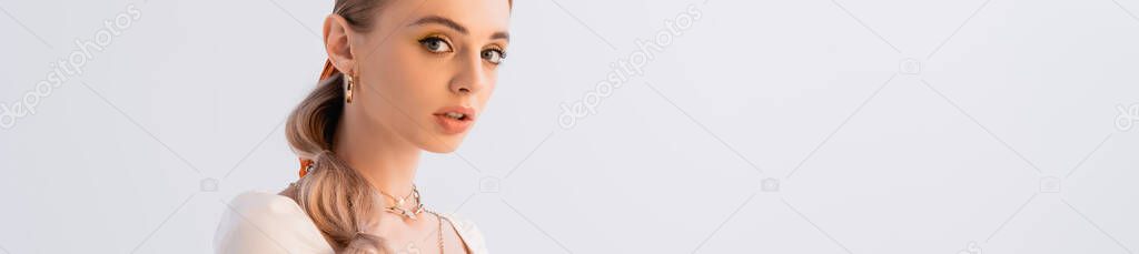 blonde woman looking at camera isolated on white, panoramic shot