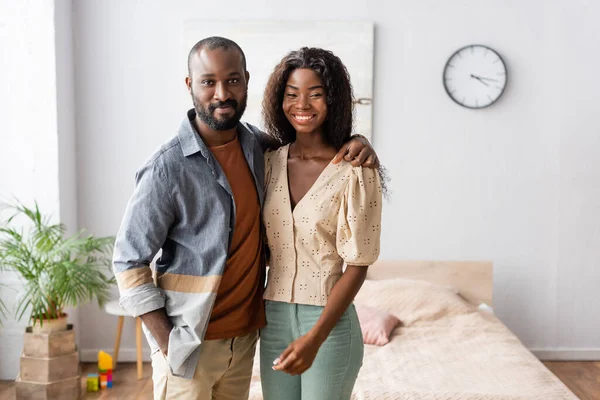 African American Man Hugging Wife While Standing Hand Pocket Bedroom — Stock Photo, Image
