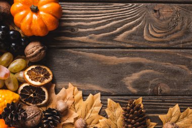 top view of autumnal harvest on brown wooden background clipart
