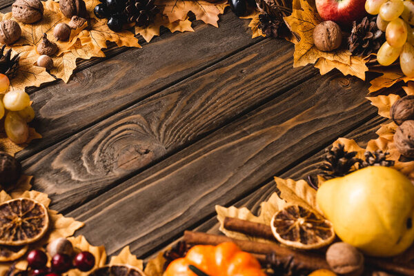 round framer of autumnal decoration on brown wooden background