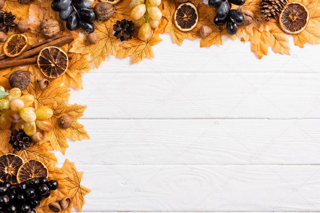 top view of autumnal decoration on white wooden background