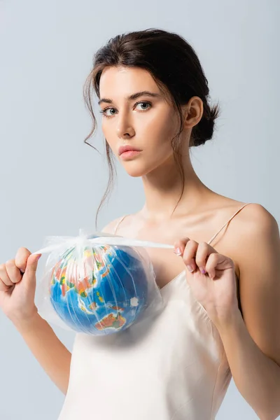 Young Brunette Woman Holding Plastic Bag Globe Looking Camera Isolated — Stock Photo, Image