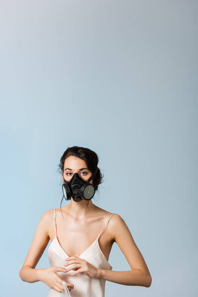 brunette woman in gas mask holding plastic bag isolated on grey, ecology concept 