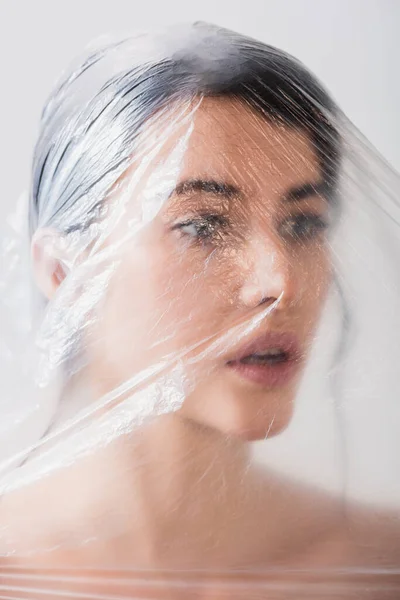 Naked Woman Open Mouth Covered Polyethylene Looking Away Isolated Grey — Stock Photo, Image