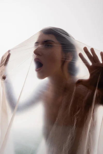 Mujer Joven Gritando Través Polietileno Aislado Blanco Concepto Ecología —  Fotos de Stock