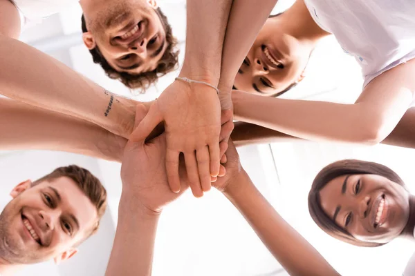 Bottom View Multicultural Volunteers Looking Camera While Holding Hands — Stock Photo, Image