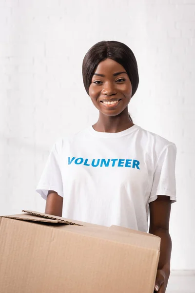Afrika Amerika Sukarelawan Melihat Kamera Sambil Memegang Kotak Karton — Stok Foto