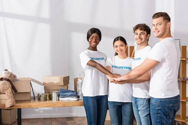 Young Multiethnic Volunteers Holding Hands Looking Camera Charity Center — Stock Photo, Image