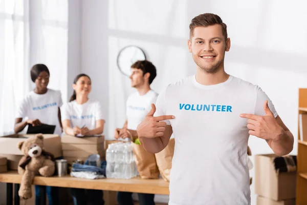 Selective Focus Volunteer Looking Camera Pointing Fingers Shirt Lettering — Stock Photo, Image