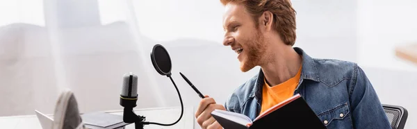 Horizontal Image Excited Broadcaster Talking Microphone While Holding Pen Notebook — Stock Photo, Image