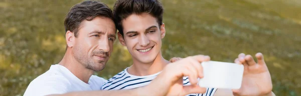 Panoramic Crop Father Teenager Son Taking Selfie Park — Stock Photo, Image