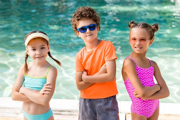 Girls Swimsuits Curly Boy Sunglasses Standing Crossed Arms Pool — Stock Photo, Image