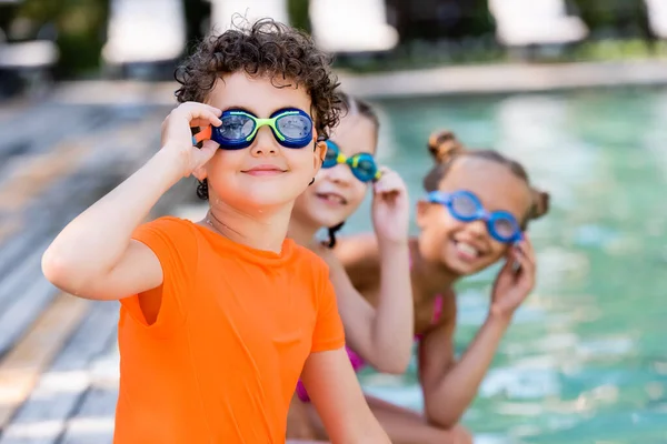 Selective Focus Friends Touching Swim Goggles While Looking Camera — Stock Photo, Image