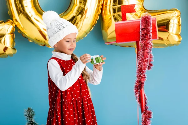 Girl Hat Winter Outfit Holding Present Red Mailbox Blue — Stock Photo, Image