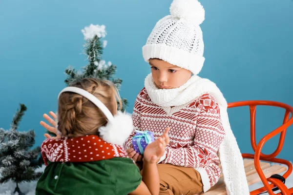 Selective Focus Boy Knitted Hat Holding Present While Sitting Sleight — Stock Photo, Image