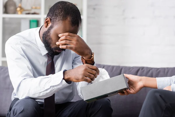 Stressed African American Man Covering Eyes Hand While Taking Paper — Stock Photo, Image