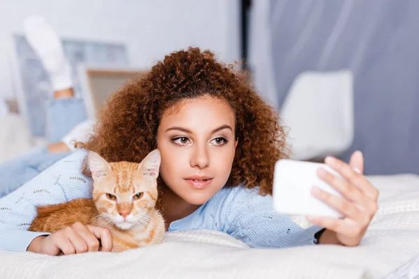 Selective Focus Curly Woman Taking Selfie Cat Bed — Stock Photo, Image