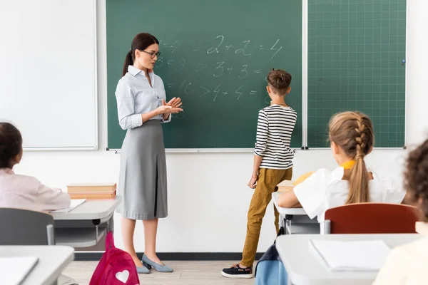 Terug Zicht Schooljongen Oplossen Vergelijkingen Schoolbord Tijdens Wiskundeles Buurt Van — Stockfoto