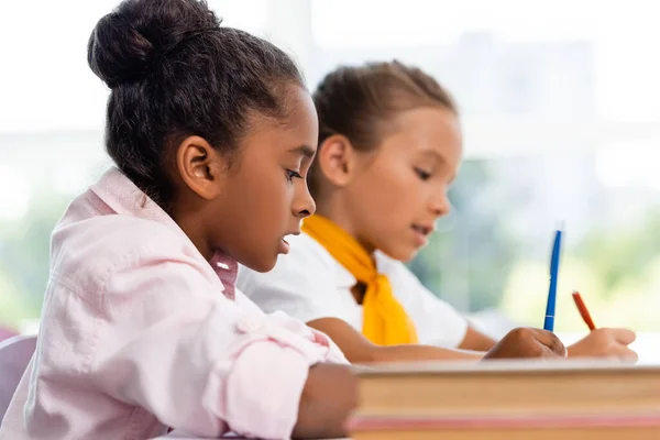 Selective Focus African American Schoolgirl Holding Pen Friend Books Classroom — Stock Photo, Image