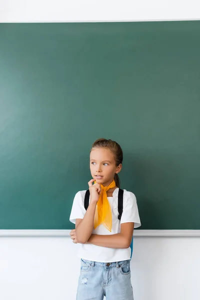 Töprengő Iskolás Lány Hátizsákkal Néz Félre Közel Zöld Tábla Osztályteremben — Stock Fotó
