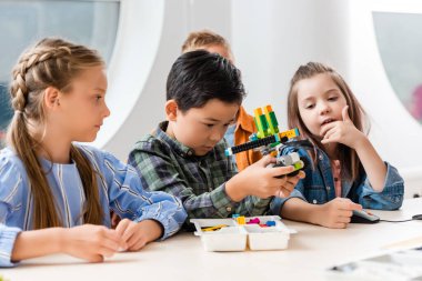 Çok ırklı okul çocuklarının seçici odak noktası kök okulunda robot modelliği. 