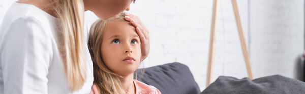 Website header of woman touching head of sick daughter 