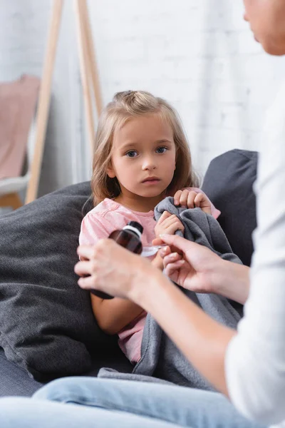 Selective Focus Woman Pouring Syrup Sick Daughter Blanket Sofa — Stock Photo, Image