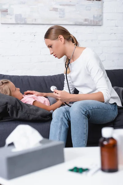 Selective Focus Woman Stethoscope Touching Sick Daughter Napkins Syrup Coffee — Stock Photo, Image